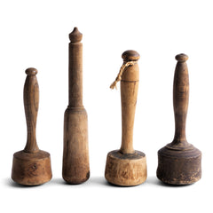 A collection of particularly pleasing antique turned wooden pestles. Now retired from their original use, they would make wonderful decorative objects for the home, and their century of use has given each a beautiful patina.