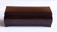 A rare Bakelite box of casket shape on four small stepped feet.