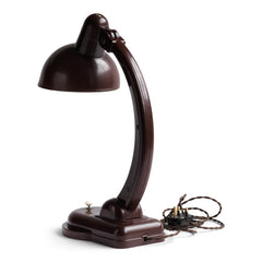 A rare Sigma Bakelite desk lamp designed in the 1940s by Christian Dell at the Bauhaus, Germany, for manufacturer Heinrich Römmler. It has a pivoting arm and adjustable shade for directional lighting, making it ideal for the desk or the bedside table. Constructed of deep chocolate brown Bakelite, it has an on/off switch, and is rewired with cloth covered electrical cable.