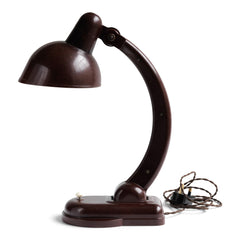 A rare Sigma Bakelite desk lamp designed in the 1940s by Christian Dell at the Bauhaus, Germany, for manufacturer Heinrich Römmler. It has a pivoting arm and adjustable shade for directional lighting, making it ideal for the desk or the bedside table. Constructed of deep chocolate brown Bakelite, it has an on/off switch, and is rewired with cloth covered electrical cable.