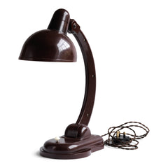 A rare Sigma Bakelite desk lamp designed in the 1940s by Christian Dell at the Bauhaus, Germany, for manufacturer Heinrich Römmler. It has a pivoting arm and adjustable shade for directional lighting, making it ideal for the desk or the bedside table. Constructed of deep chocolate brown Bakelite, it has an on/off switch, and is rewired with cloth covered electrical cable.