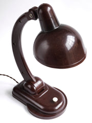 A rare Sigma Bakelite desk lamp designed in the 1940s by Christian Dell at the Bauhaus, Germany, for manufacturer Heinrich Römmler. It has a pivoting arm and adjustable shade for directional lighting, making it ideal for the desk or the bedside table. Constructed of deep chocolate brown Bakelite, it has an on/off switch, and is rewired with cloth covered electrical cable.