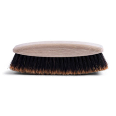 Our handmade butler's brush is made from hand-tufted split horsehair secured in a rounded beechwood handle. Its grooming uses go beyond the brushing down of jackets and trousers, as it can be used for the sweeping of crumbs from the tablecloth or tabletop, or to buff shoes.