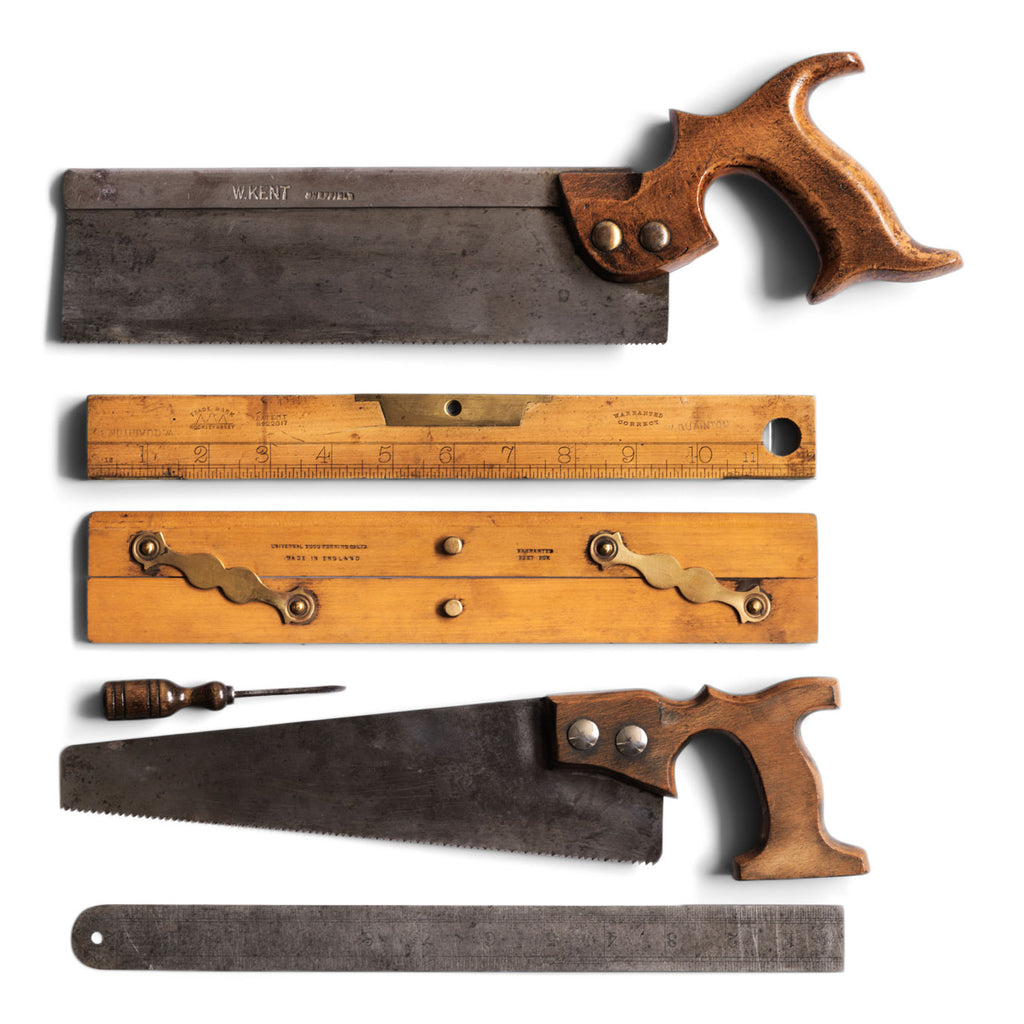 A collection of 1930s vintage woodwork tools: a saw by "W Kent Sheffield", length 37cm; a carpenter's combined spirit level and inch rule, length 31cm; a draughtsman's parallel rule with brass hinges and imprinted with "Universal Wood Working Co Ltd Made in England - Warranted Best Box", length 31cm; a screwdriver with turned wood handle, length 10.5cm; a small hand saw, length 34cm; and a 12" steel rule.