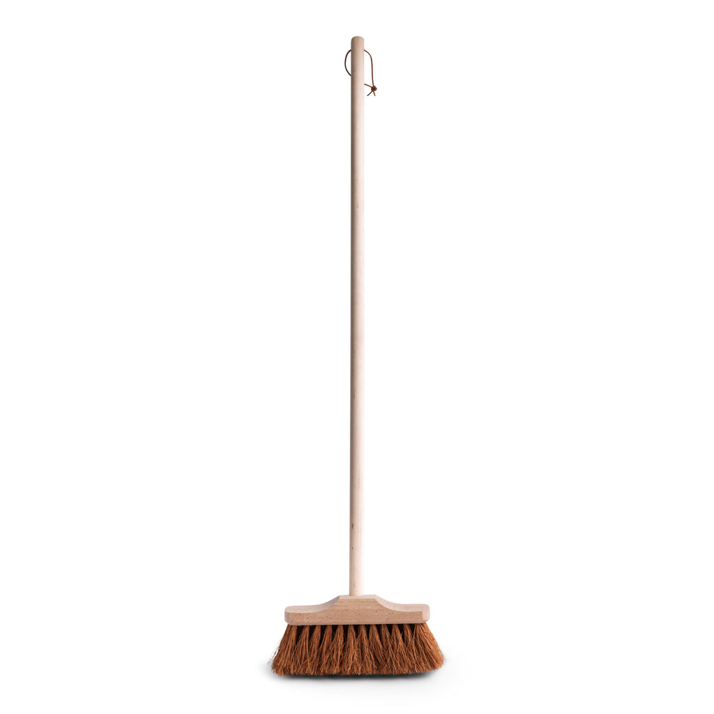 A small, nifty little broom with a narrow head of coconut bristles and a shorter handle than normal.  Excellent for sweeping in and around nooks and crannies, and between awkward spaces such as chair legs; and it can be readily used outside, for a quick sweep around the the terrace or path.