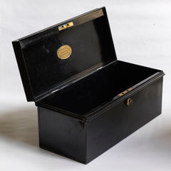A handy little tin and of beautiful proportion retailed by the grand department store Gamages of London, and with its original black laquered paint finish. Inside the hinged lid is affixed an oval gold plaque embossed with “Trunk & Bag Department - A W Gamage Ltd, Holborn, London EC1”. It has a simple carrying handle and lock with original key.