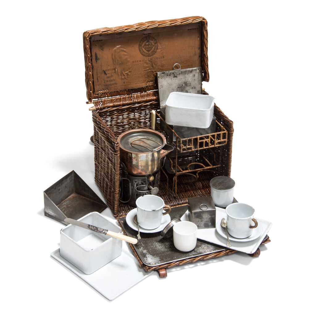 An original Edwardian Drew & Sons En Route tea basket travelling picnic set in white enamel, steel and nickel, with handwoven rattan detailing. Drew & Sons “As supplied to her majesty the queen” (Queen Mary) were the Rolls Royce of picnic set makers, and were originally based in Piccadilly, London – which is where this set was originally retailed. Their picnic sets are rare to find, let alone in such good condition, and are now highly sort after.