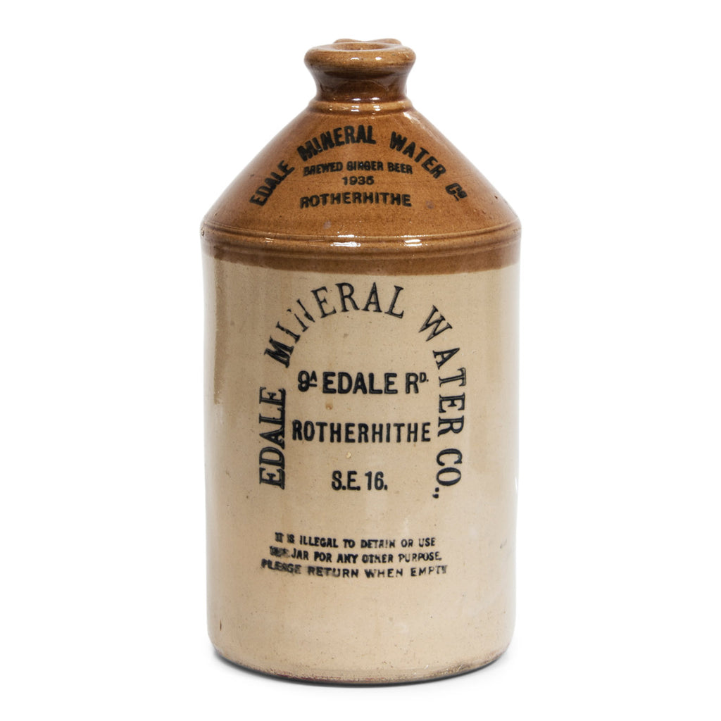 A handsome 1930s flagon with strap handle and bold utilitarian typeface: "Edale Mineral Water Co Brewed Ginger Beer 1935 9a Edale Rd Rotherhithe S.E.16 - it is illegal to detain or use this jar for any other purpose, please return when empty". 