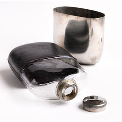 A very handsome Edwardian silver plated, glass and black leather 1/2 pint hip flask with a screw-cap top by "James Dickson & Sons Sheffield". The clear glass body is half covered with leather, the upper half has a detachable silver plated cover that also acts as a cup.