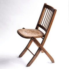 We have a run of these elegant Edwardian folding chairs, which were purchased some years back directly from the church hall in Winchelsea, East Sussex, UK. The seats are of ply with a pierced star pattern; the backs spindle slatted and each frame is beautifully constructed from solid walnut and designed to fold flat.