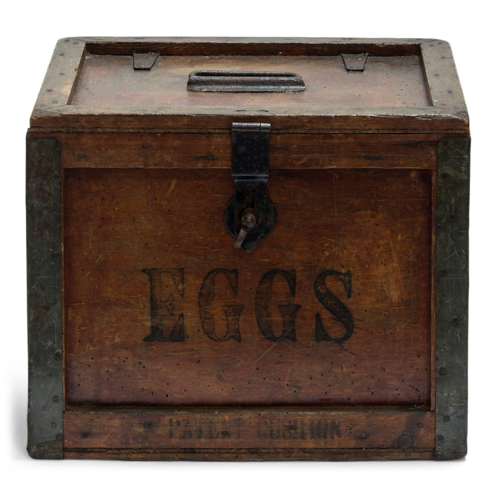 A very handsome 1920s egg travelling box, recently purchased from a farm sale in Hertfordshire, UK. The lid, and all four side panels are stencilled "Eggs", and various extra stamps, as shown in the images. It has a bracket hinged lid with carrying handle, reinforced metal trim corners, and a hasp. Inside the lid it still has its original maker's paper label, applied by the "Dairy Outfit Company Ltd, Kings Cross, London N1".