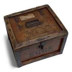 A 1920s egg travelling box, once used at Ewart Hebdish South Somerset Poultry Farm, Martock, Somerset, UK - as stamped on the lid. All four side panels and the lid are stencilled "Eggs", and various extra stamps, as shown in the images. It has a bracket hinged lid with carrying handle, reinforced metal trim corners, and a hasp. Inside the lid it still has its original maker's paper label, applied by the "Dairy Outfit Company Ltd, Kings Cross, London N1"