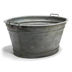 An extra-large galvanised oval tub with twin handles and rolled rim - an ideal garden planter.