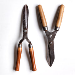 Two pairs of good quality vintage ladies' garden shears, both with polished wooden handles and polished sharp steel blades.&nbsp;