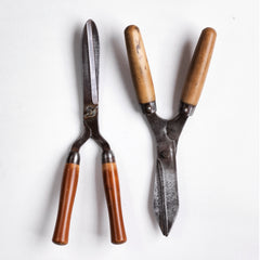 Two pairs of good quality vintage ladies' garden shears, both with polished wooden handles and polished sharp steel blades. 