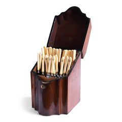 A handsome George III mahogany veneered knife box with a flower basket oval inlay on its slanting lid; a serpentine front banded in satinwood; and a compass star decoration with rope cross-banded inlay applied to the underside of its lid. The base is felt baize covered, and it has a copper escutcheon and lid pull. 
