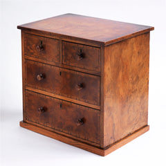 Our gorgeous early nineteenth century tabletop set of drawers are attributed to Gillows of Lancaster and comprise of two long and two short drawers, each retaining its original pair of turned wooden knobs. Veneered in figured walnut, cross-banded in exotic wood veneers and French polished, it is a stunner, and in wonderful condition. The two long drawers have brass locks with brass escutcheons, and the middle drawer contains divisions.