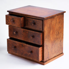 Our gorgeous early nineteenth century tabletop set of drawers are attributed to Gillows of Lancaster and comprise of two long and two short drawers, each retaining its original pair of turned wooden knobs. Veneered in figured walnut, cross-banded in exotic wood veneers and French polished, it is a stunner, and in wonderful condition. The two long drawers have brass locks with brass escutcheons, and the middle drawer contains divisions.