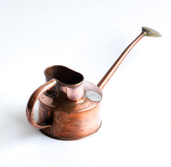 An elegant vintage Haws copper watering can, designed to be used in a greenhouse for watering seedlings or indoors for houseplants. The brass rose can be easily removed for more directional watering and is stamped "Haws Genuine". It still retains its original paper roundel that reads "The genuine Haws, Made in England", which is also stamped into the copper on the underside.