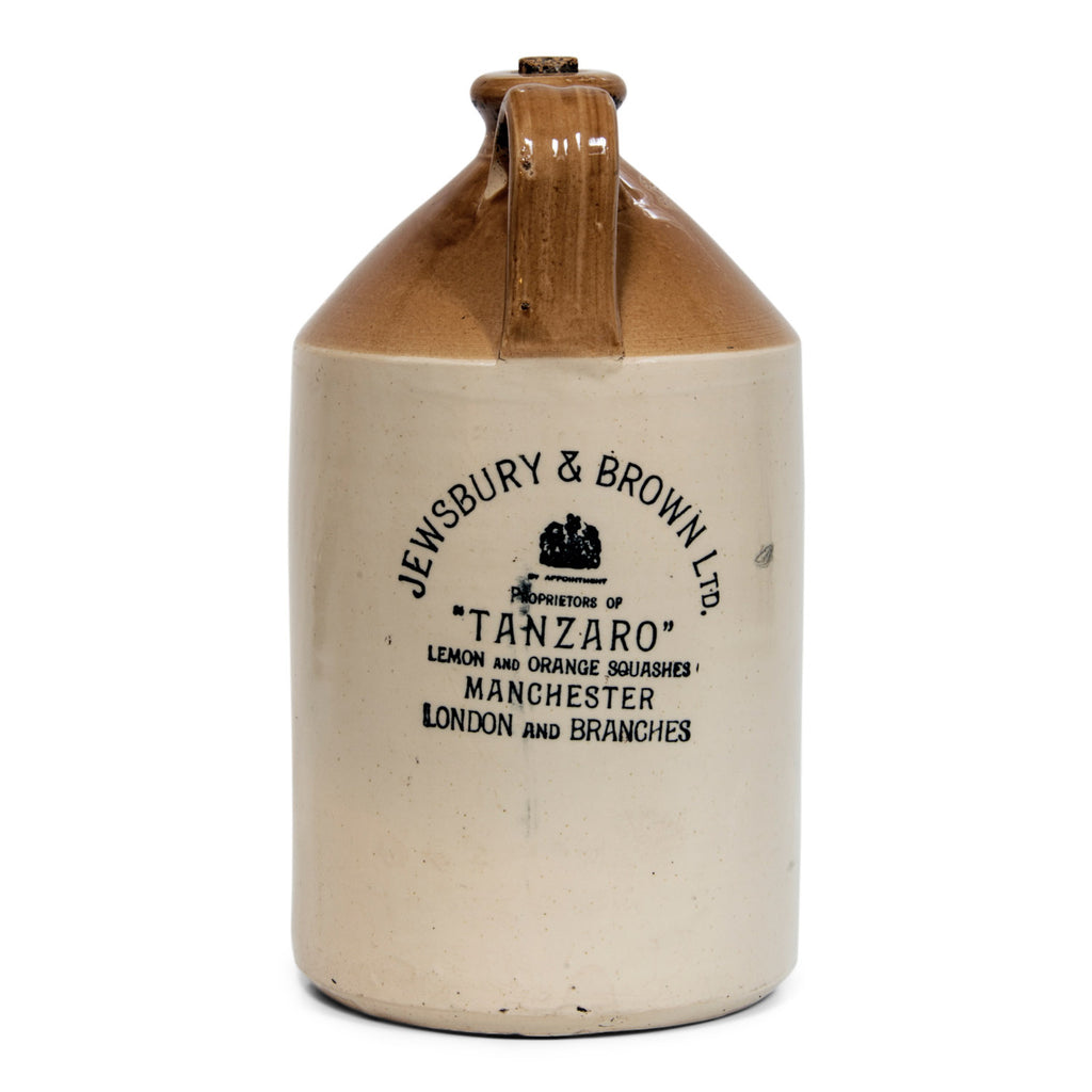 A handsome Edwardian flagon with strap handle and bold utilitarian turn-of-the-century century typeface: "Jewsbury & Brown Ltd Proprietors of 'Tanzaro' Lemon and Orange Squashes Manchester London and Branches".