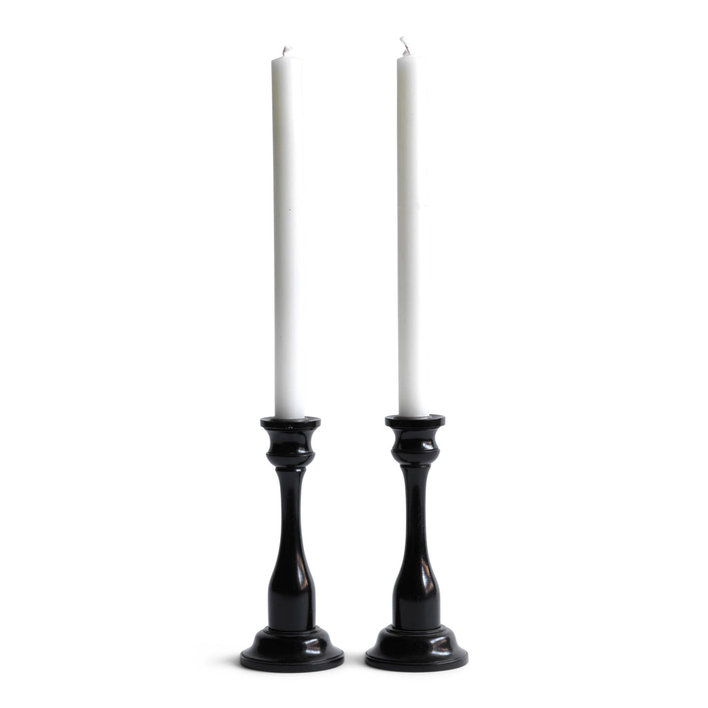 A striking pair of Edwardian ebony candlesticks