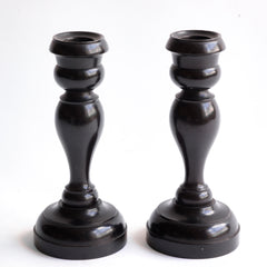 A striking pair of Edwardian ebony candlesticks. 