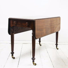 An elegant high quality solid mahogany Regency Pembroke table with single drawer on four faceted and turned legs, set on castors. A very handy and compact piece of furniture for the smaller home.  When part extended it can be used as a desk or for supper for two; fully extended it can seat several people for dinner; and when fully collapsed it can act as a hall or side table.