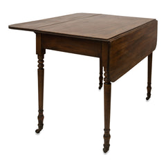 An elegant early Victorian mahogany Pembroke table with single drawer on four turned legs set on castors. A very handy and compact piece of furniture for the smaller home: when part extended it can be used as a desk or for supper for two; fully extended it can seat several people for dinner; and when fully collapsed it can act as a hall or side table.