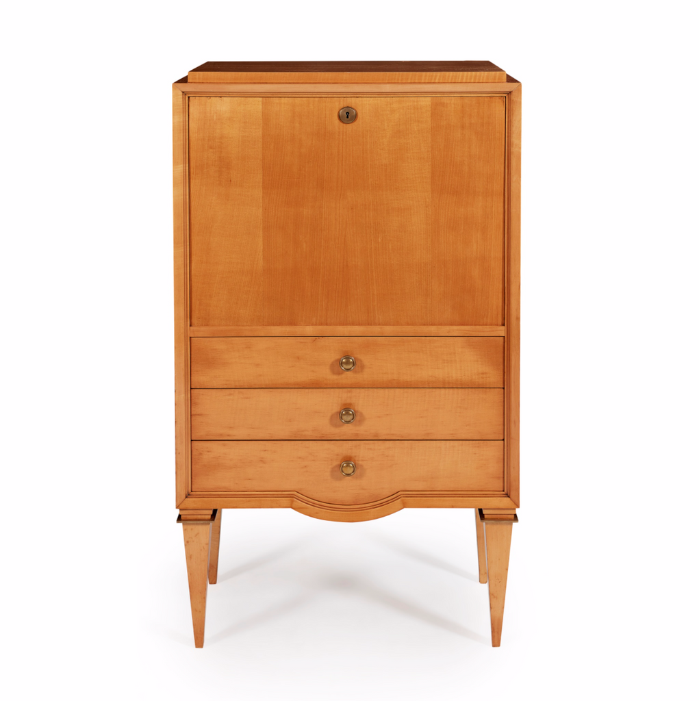 A stunning 1940s satin birch secrétaire attributed to André Arbus. The plain fall front opens to reveal a fitted interior above three drawers and square tapering legs with decorative brass capitals. The centralised demi-lune detail of the lower drawer facade; the exaggerated taper of the squared legs, and their decorative brass capitals, are all hallmark Arbus design details and characteristic of the designer's peak, his 1940s "neoclassique" period.