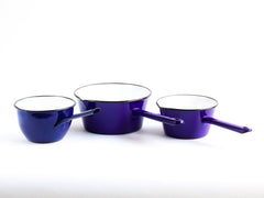 A set of three vintage violet-blue enamel saucepans.