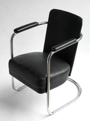 An elegant and rare tubular steel modernist armchair attributed to PEL (Practical Equipment Ltd) with continuous tubular chrome frame and horseshoe cantilever base. The chromium plated steel wraps around the back and forms the armrests, and it is upholstered in its original black leatherette.