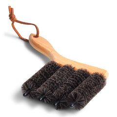 A brush designed to clean Venetian blinds made from all natural products, beechwood and goat hair, and with a handy leather strap for hanging.