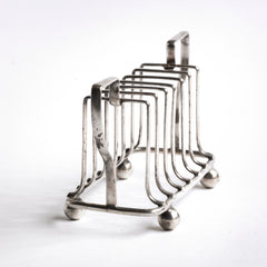 An Edwardian twin handled silver plated toast rack with ball feet.