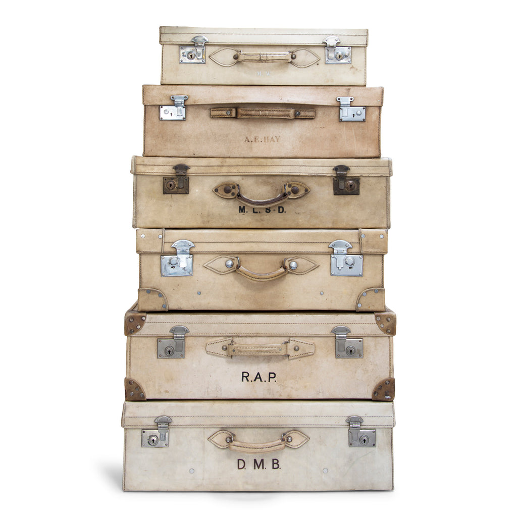 A collection of glamorous 1920s vellum luggage made from bleached cowhide and fitted with nickel plated fittings. One can but wonder what grand tours and travels they have seen. Their travels are over, yet now they are perfect for bedroom blanket, clothes or shoe storage, and make very handsome low level coffee-tables.