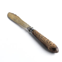 A rare late nineteenth century butter knife with a silver plated blade and the word "Butter" carved into its wooden handle.