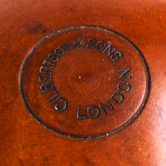 A large Victorian apothecary’s bottle holder made from a single piece turned and polished boxwood, and is a beautiful example of 19th century chemist’s treen. The container holds its original bottle with stopper; the threaded screw-on lid turns beautifully; and the top of the lid is embossed “Gilbertson & Sons London”.