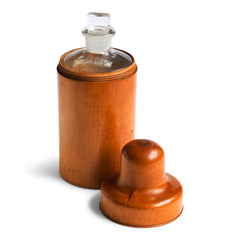 A large Victorian apothecary’s bottle holder made from a single piece turned and polished boxwood, and is a beautiful example of 19th century chemist’s treen. The container holds its original bottle with stopper; the threaded screw-on lid turns beautifully; and the top of the lid is embossed “Gilbertson & Sons London”.