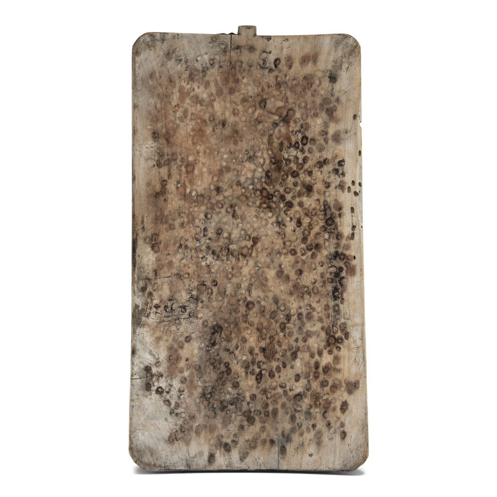 An extra large antique baker's board with a wonderful knotted wood patina and a charming metal repair to its top edge.
