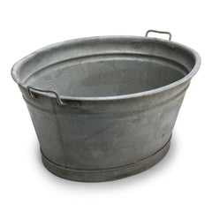 An extra-large galvanised oval tub with twin handles and rolled rim - an ideal garden planter.