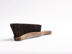 A handsome war office boot brush made of natural bristle and beech wood, and stamped with a broad arrow that denotes its military use.