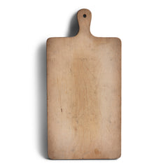 A charming vintage chopping board with handle and hanging hole. Its time-worn surface has a wonderful patina.