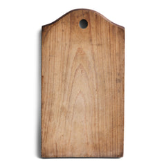 A charming vintage chopping board with an arched end and hanging hole. Its time-worn surface has a wonderful patina.