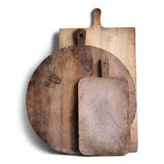 A wonderful collection of antique and vintage bread boards. Their time-worn, knife-cut surfaces are full of character and warmth. They also make excellent communal serving platters for air dried ham, antipasto, breads, cheeses, and pickles; and when not in use, look great as a backdrop when propped up on the kitchen side.