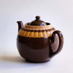A good large 6 cup original Brown Betty teapot with mustard banding and raised pie-crust style fluting.