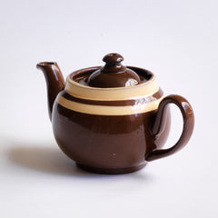 A charming little vintage Brown Betty teapot with two cream coloured bands.