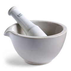 A vintage ceramic mortar & pestle with pouring lip. The mortar and pestle is made out of vitrified porcelain, making it durable and of good weight. Underneath it is stamped "GDV". 
