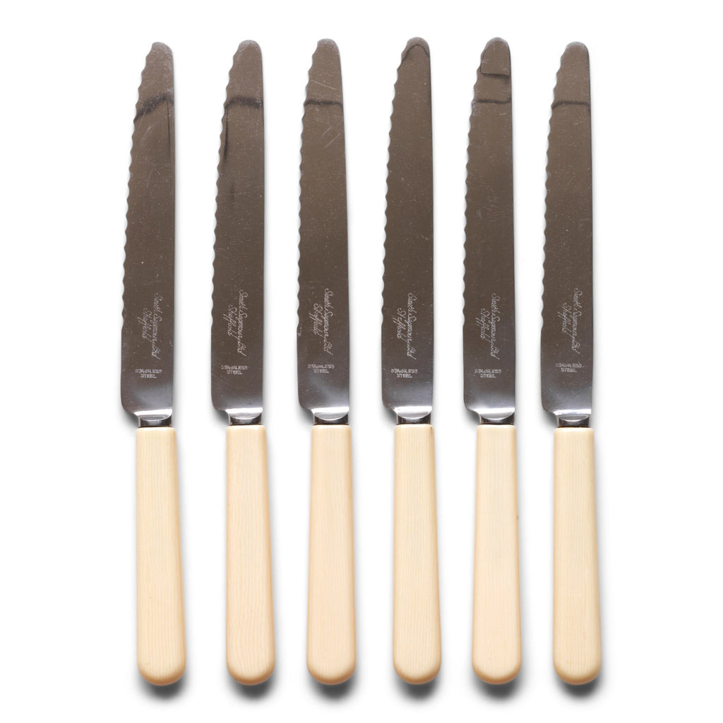 A set of 6 vintage ‘bone-handled’ serrated steak knives each marked Smith Seymour Ltd, Sheffield. 