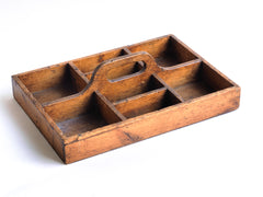 A well proportioned antique stained pine housekeeper's tidy with integrated handle. It could also be used to house utensils, tools, artist's materials or act as a shoe cleaning box. In fact it's totally purposeful.