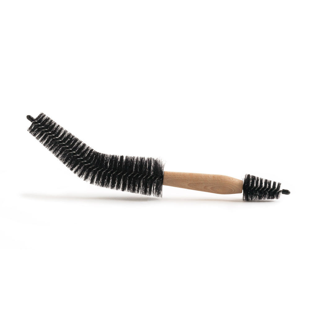 A bike brush with a beech wood handle and horsehair bristle, measuring 38cm long, with the widest diameter of bristle at 5cm.