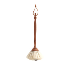 Our highly tactile handmade dusting brush has a pom-pom of soft white goat's hair that is hand-tufted onto a turned pear wood handle. This brush is ideal for all your extra delicate dusting needs, such as around ornaments, glass and delicate light fittings, such as chandeliers.  It is a beautiful brush, and you may not want to use it but simply hang it up by its leather strap and give it an occasional fondle. The small spot of black goat's hair gives it its name.